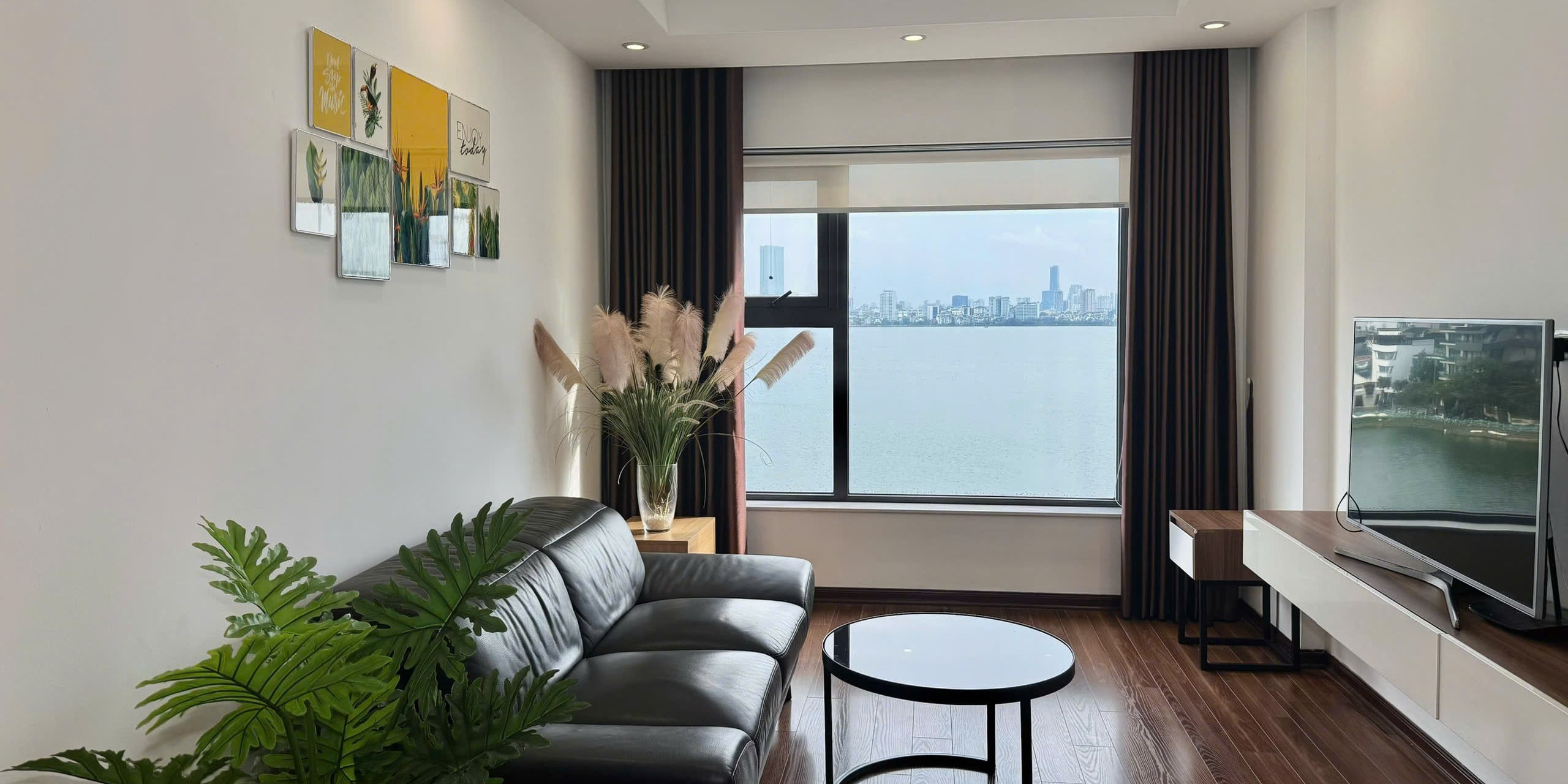 Living room with a leather sofa and a window looking across West Lake to the city skyline