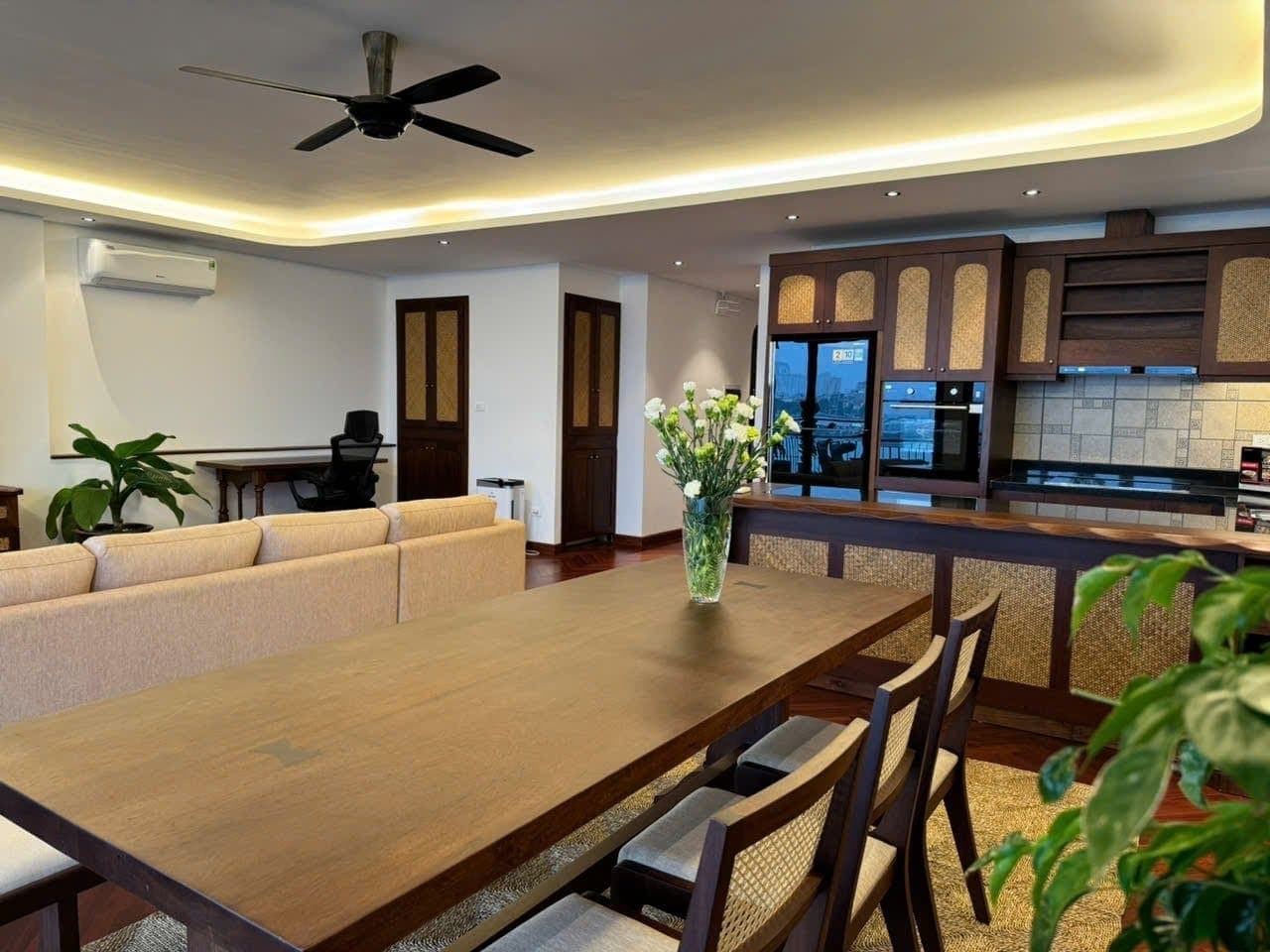A dining table and open living room in a Hanoi apartment