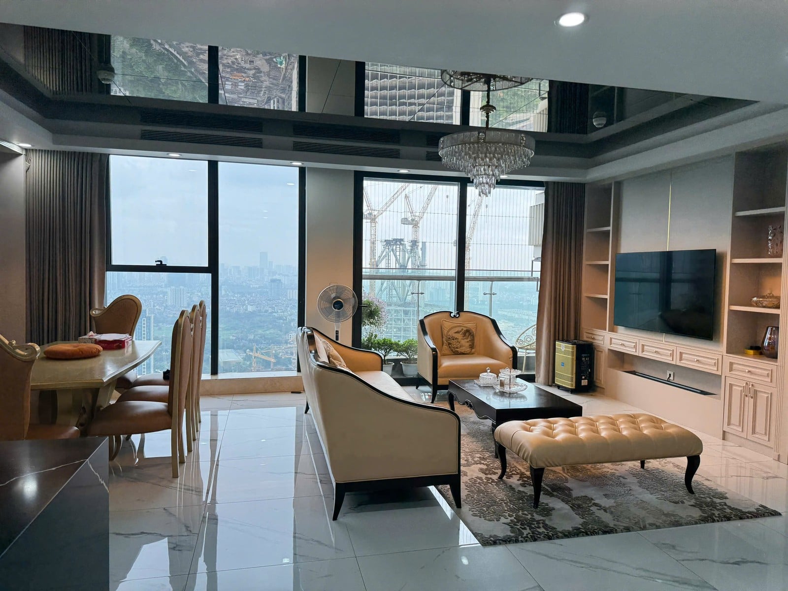 A designed lounge with a chandelier and city views