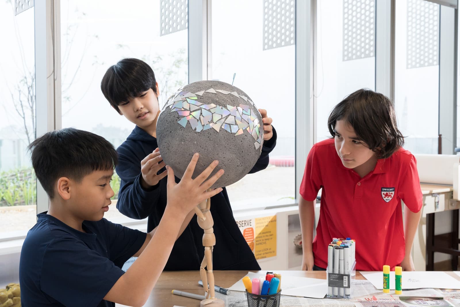 Students building a mosaic sculpture in the art studio