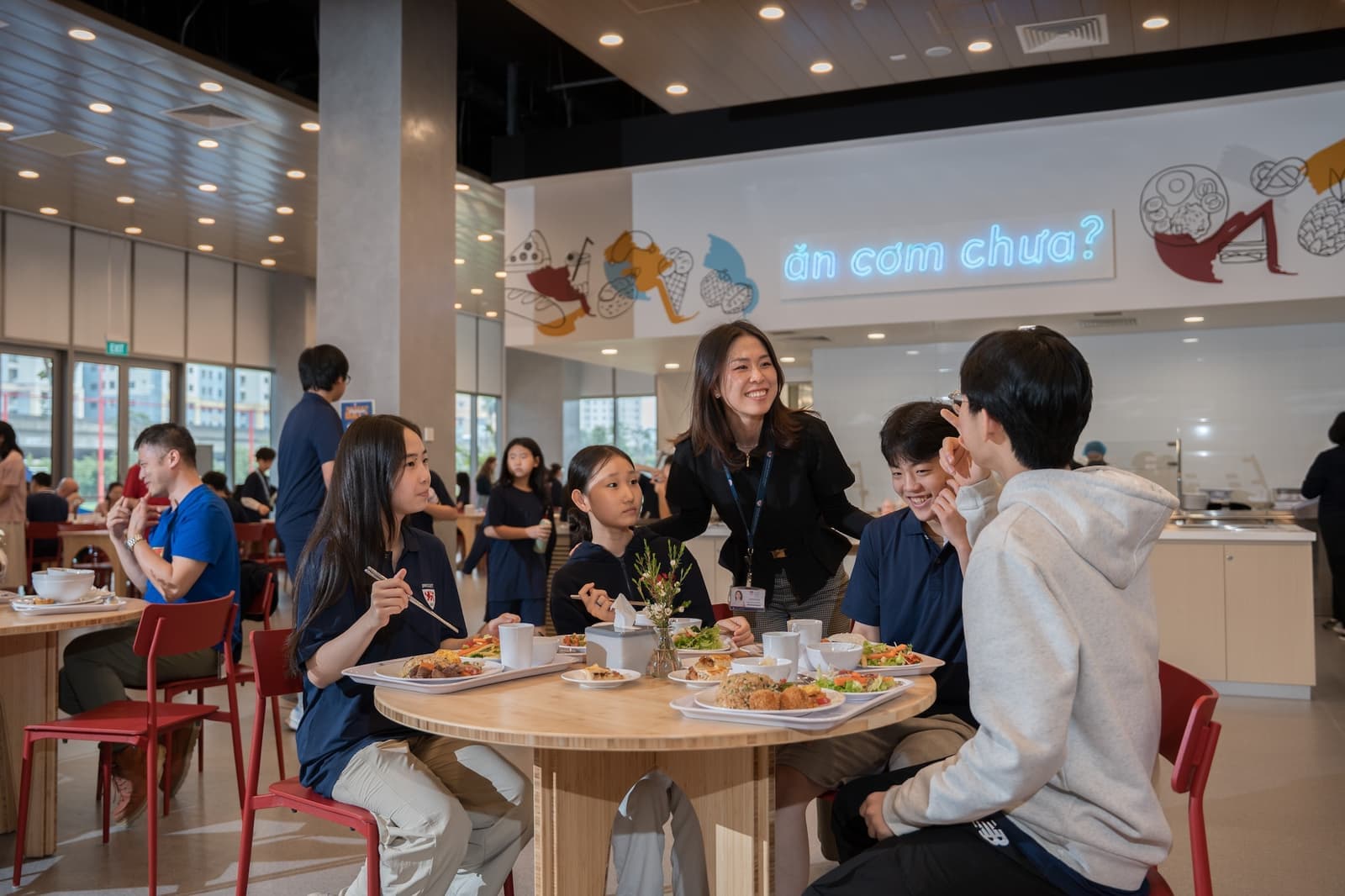 Students and staff at lunch in the dining hall