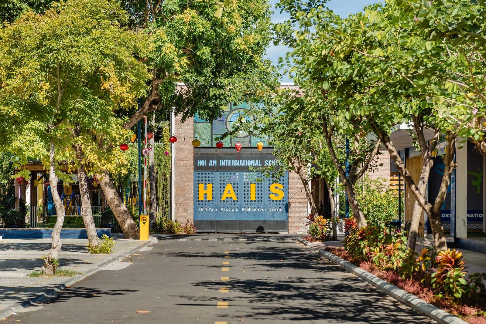 The tree-lined drive to the HAIS gate in Hoi An