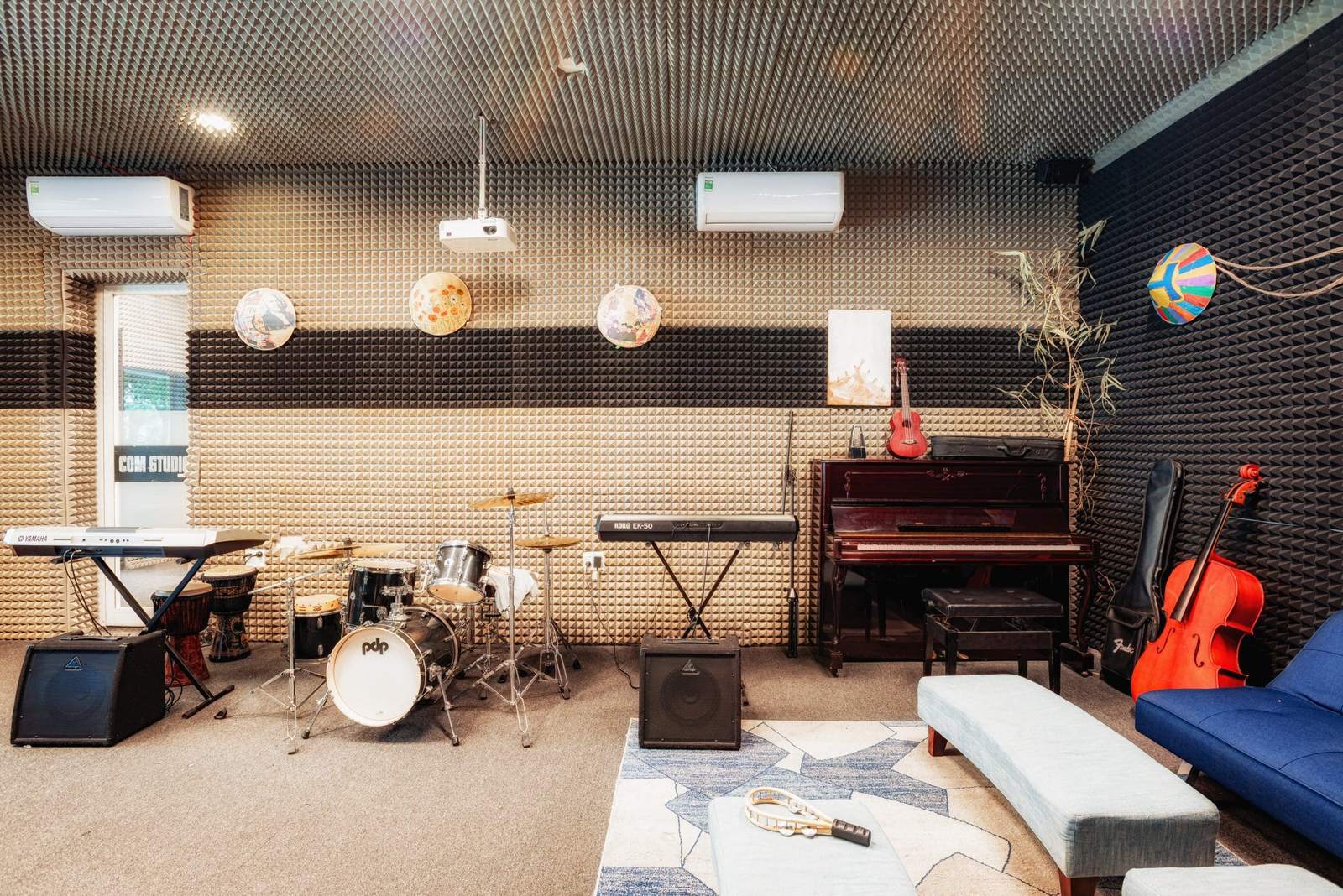 The music room, with a piano, a drum kit and guitars