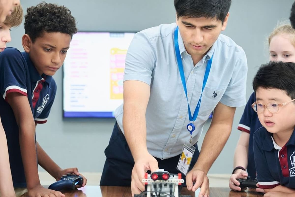 A teacher and students working on a robotics activity in a classroom at Horizon International Bilingual School