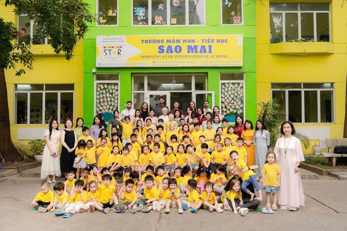 Students and staff gathered for a group photo in front of the Morning Star International School building